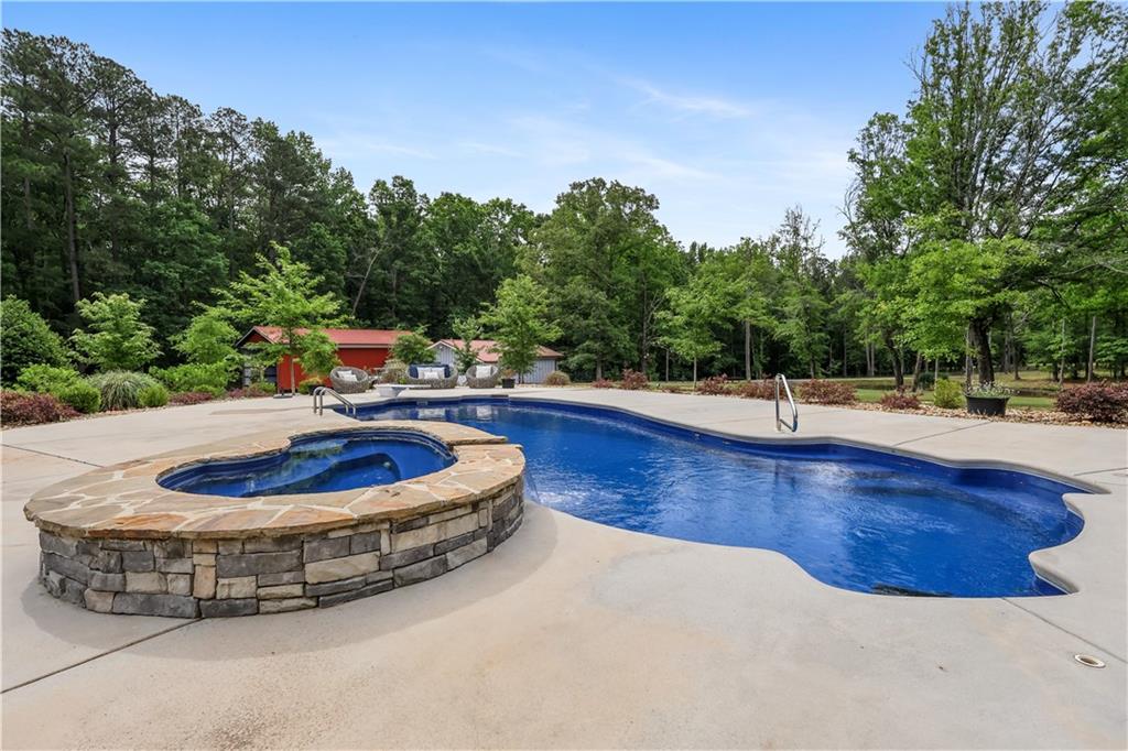 4012 Morris Road Powder Springs, GA 30127 - Photo 42 of 64 a view of a swimming pool with a sitting space