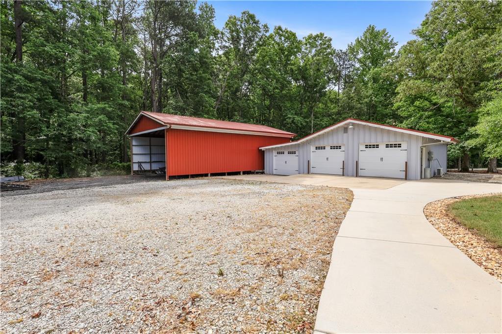 4012 Morris Road Powder Springs, GA 30127 - Photo 45 of 64 a front view of a house with a garden and yard