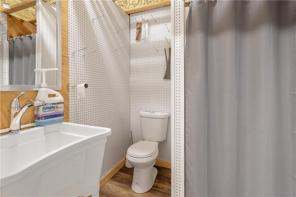 4012 Morris Road Powder Springs, GA 30127 - Photo 47 of 64 a bathroom with a sink a toilet and shower curtain