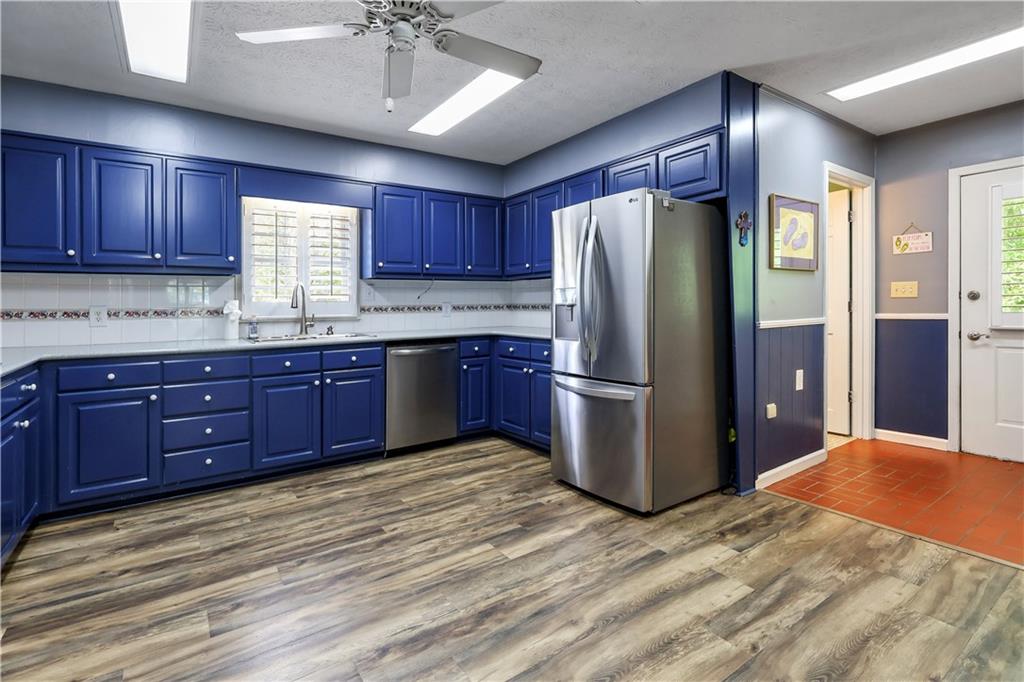 4012 Morris Road Powder Springs, GA 30127 - Photo 10 of 64 a kitchen with stainless steel appliances granite countertop a refrigerator and a sink