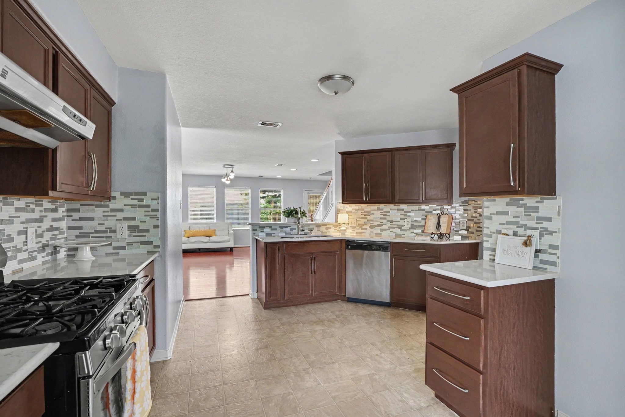 5622 Wasabi Lane Baytown, TX 77521 - Photo 5 of 29 a kitchen with stainless steel appliances granite countertop a sink stove and refrigerator