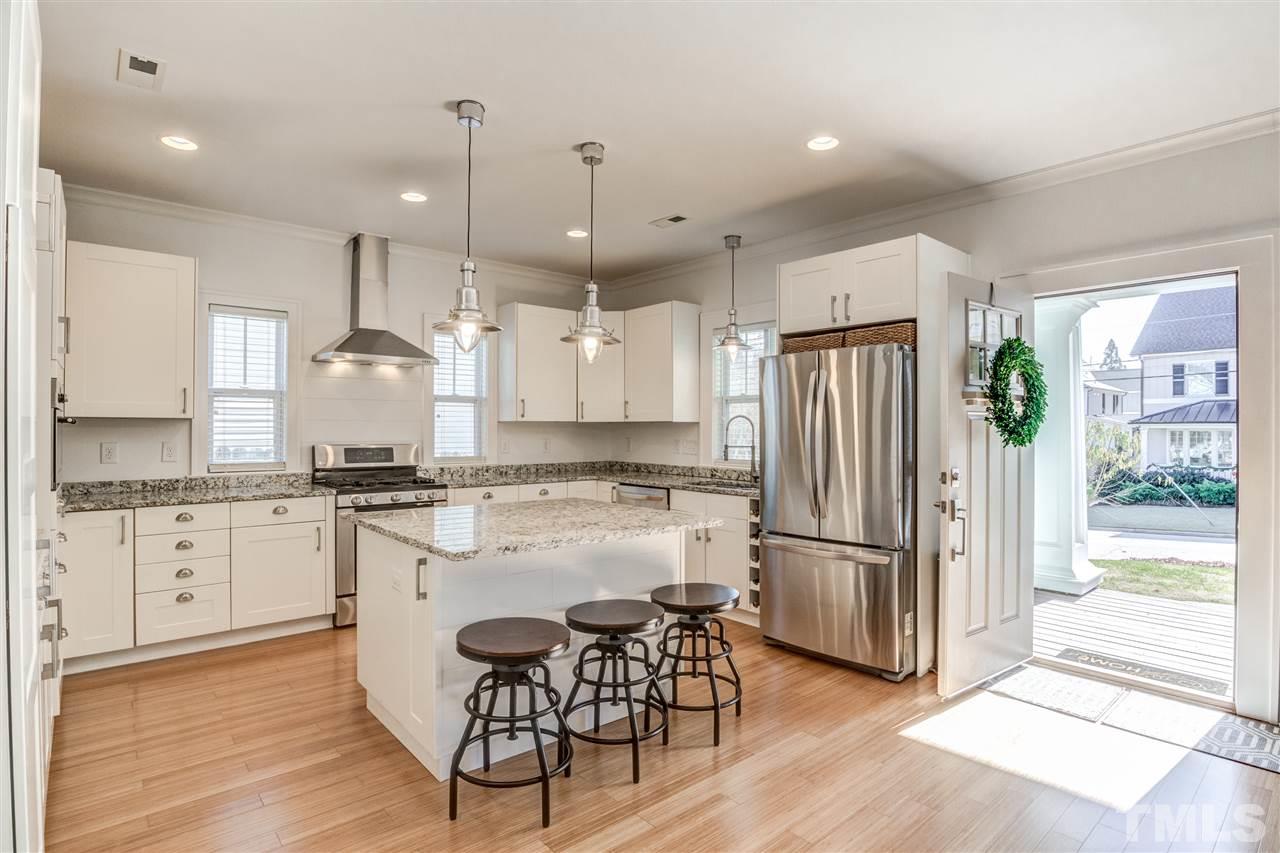 521 Mial Street Raleigh, NC 27608 - Photo 3 of 30 a kitchen with stainless steel appliances granite countertop a refrigerator a stove a sink dishwasher and a refrigerator with wooden floor