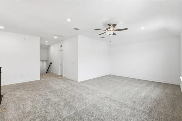 an empty room with fan and a ceiling fan