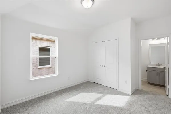 an empty room with windows and cabinet