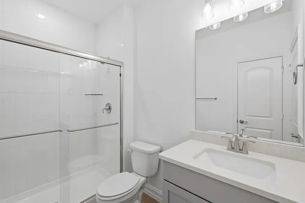 a bathroom with a sink toilet and shower