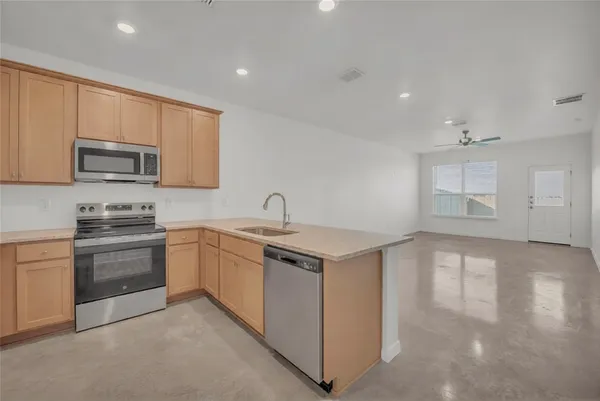 a kitchen that has a sink and a stove top oven