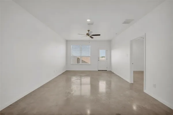 an empty room with a empty space and windows