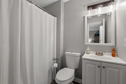 a white toilet sitting next to a bathroom sink