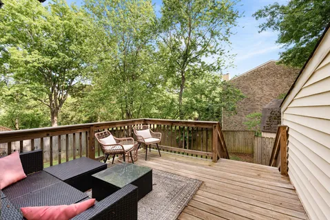a view of a balcony with wooden floor and furniture