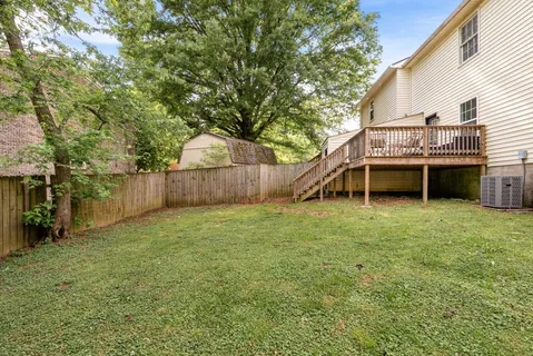 a view of a house with a backyard