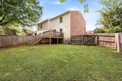 a view of a house with a yard and sitting area