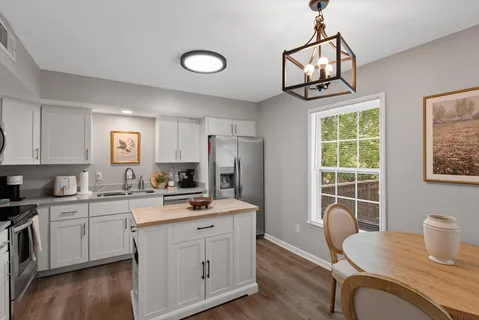 a kitchen with stainless steel appliances a sink stove and cabinets