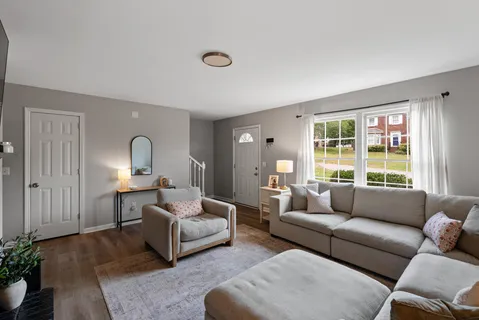 a living room with furniture and a large window