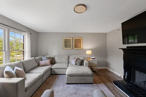 a living room with furniture flat screen tv and a fireplace