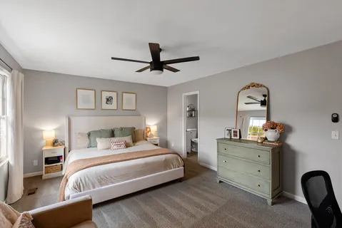 a bedroom with a bed and a chandelier
