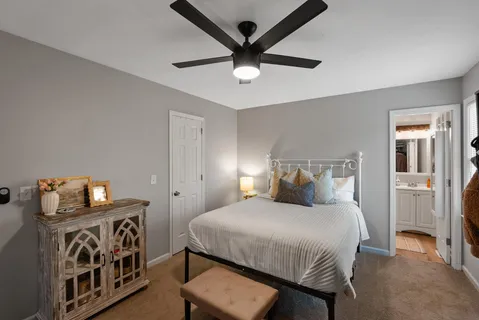 a bedroom with a bed and a chandelier