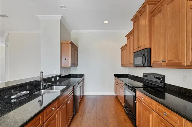 a kitchen with stainless steel appliances granite countertop a sink stove and refrigerator