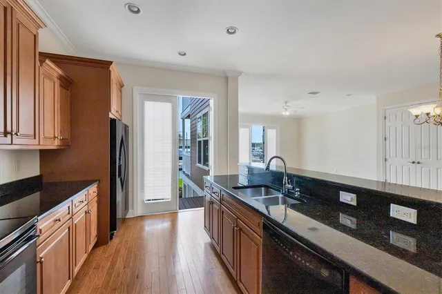 a kitchen with granite countertop a sink and cabinets