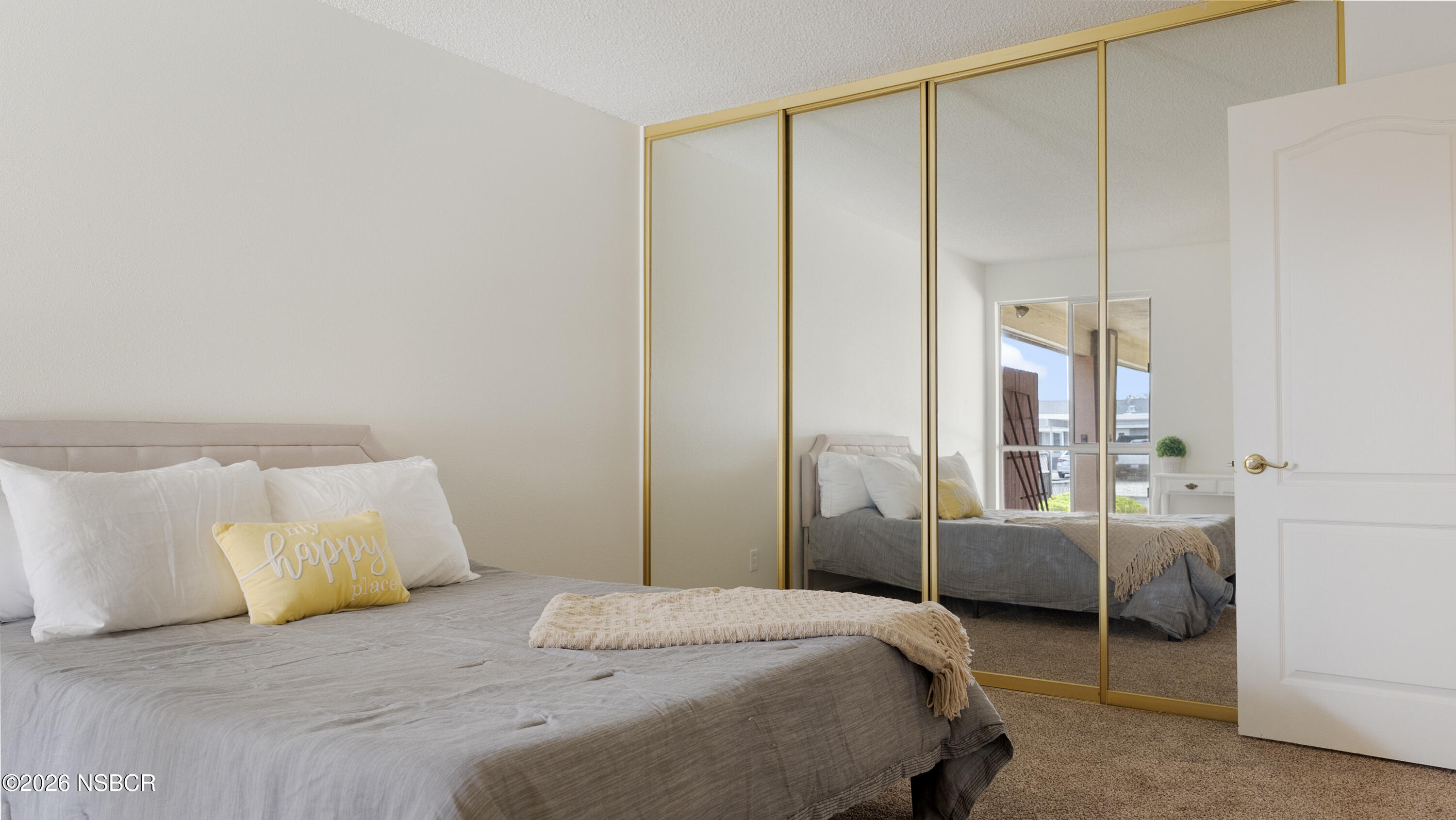 1312 North First Place Lompoc, CA 93436 - Photo 28 of 38 a bedroom with a bed and a mirror