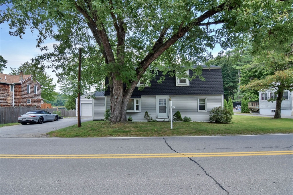 438 Boston Post Road Amherst, NH 03031 - Photo 1 of 32 a front view of a house with a yard and garage