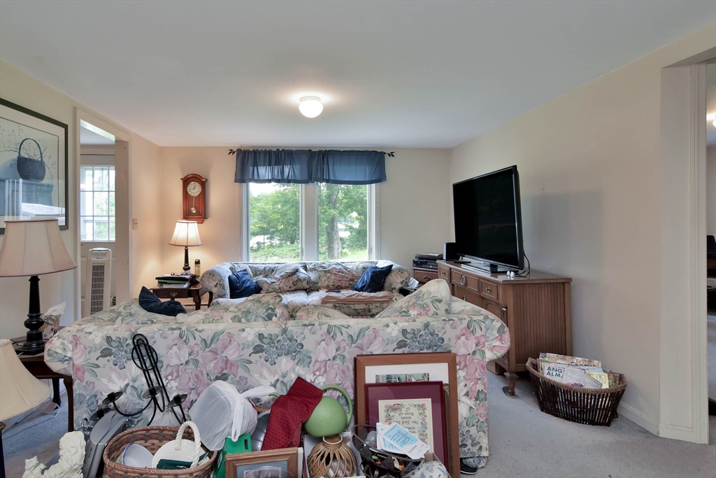 438 Boston Post Road Amherst, NH 03031 - Photo 12 of 32 a bedroom with furniture and a flat screen tv