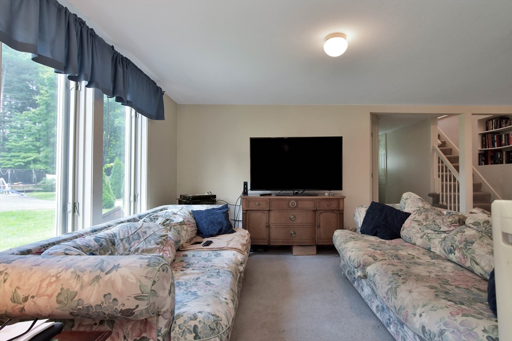 438 Boston Post Road Amherst, NH 03031 - Photo 14 of 32 a living room with furniture and a flat screen tv