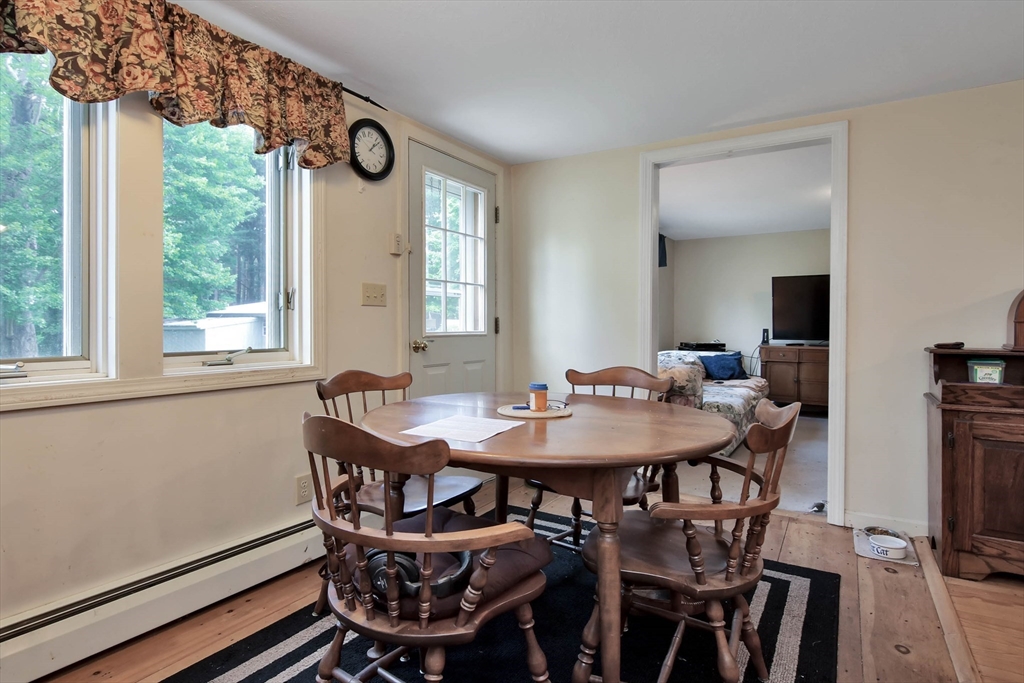 438 Boston Post Road Amherst, NH 03031 - Photo 15 of 32 a view of a dining room with furniture and window
