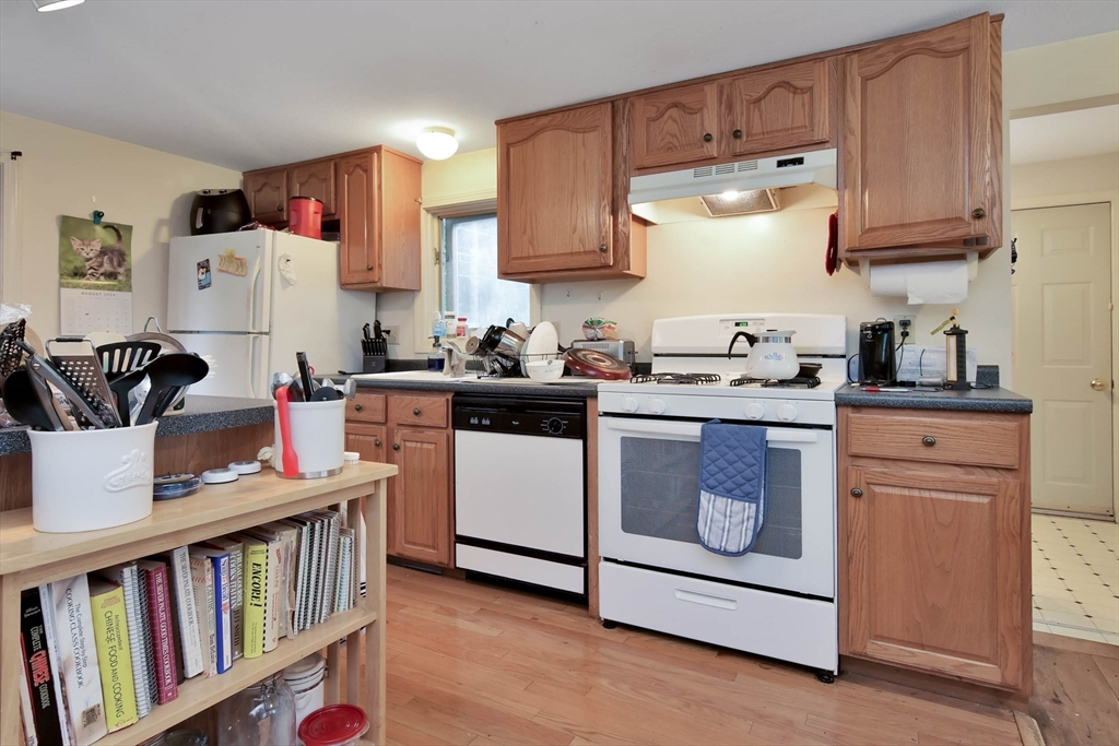 438 Boston Post Road Amherst, NH 03031 - Photo 17 of 32 a room with cabinets appliances wooden floor and a window