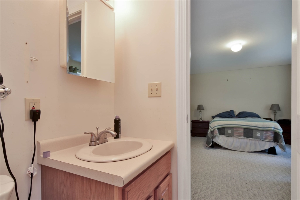 438 Boston Post Road Amherst, NH 03031 - Photo 27 of 32 a bathroom with a sink and a mirror