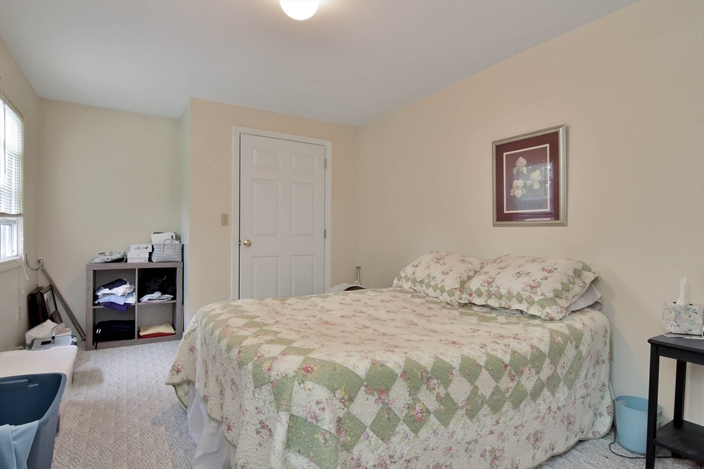 438 Boston Post Road Amherst, NH 03031 - Photo 31 of 32 a bedroom with a bed and wooden floor