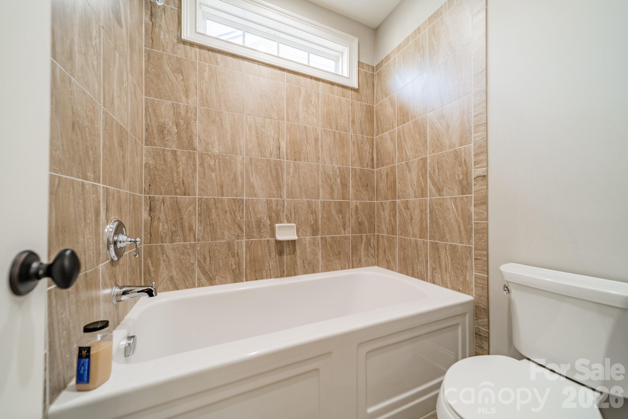 131 Boyce Road Charlotte, NC 28211 - Photo 35 of 48 a bathroom with a bathtub and a toilet