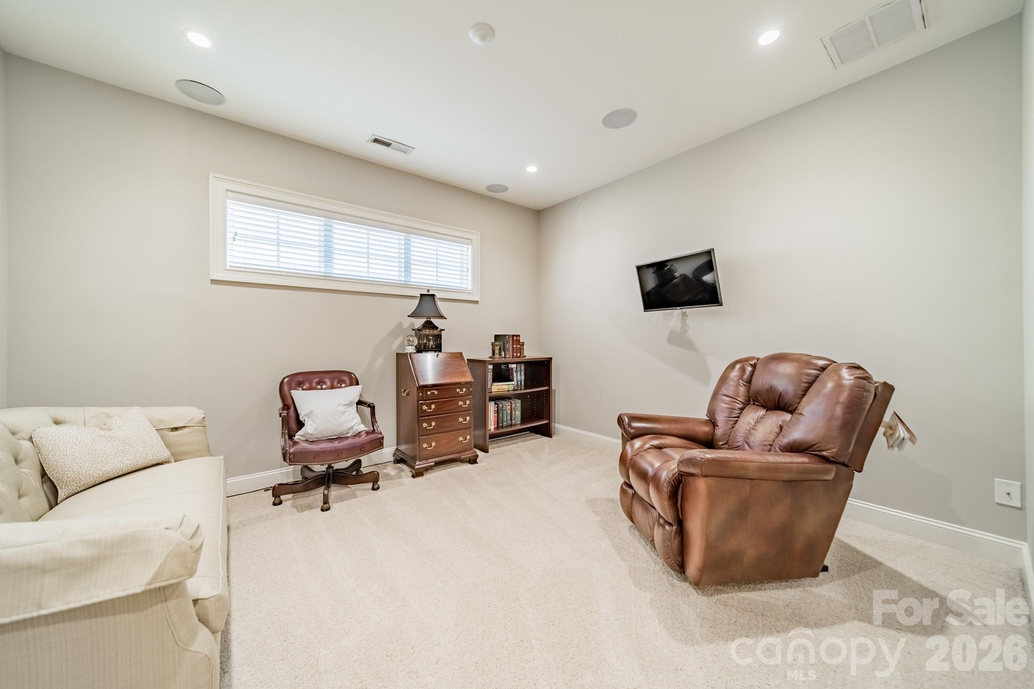 131 Boyce Road Charlotte, NC 28211 - Photo 37 of 48 a living room with furniture and a flat screen tv