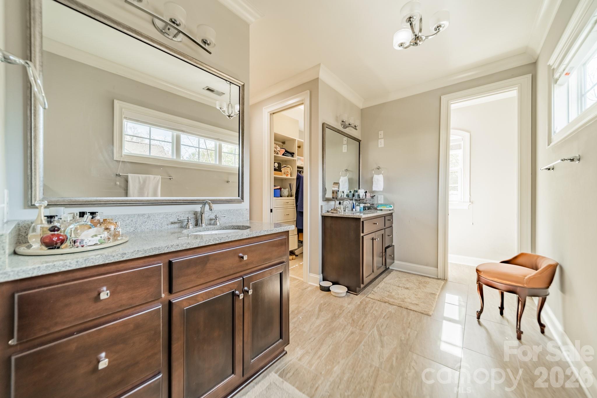 131 Boyce Road Charlotte, NC 28211 - Photo 44 of 48 a spacious bathroom with a granite countertop sink a toilet and a mirror