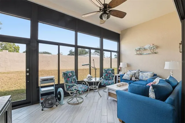 a living room with furniture and a large window