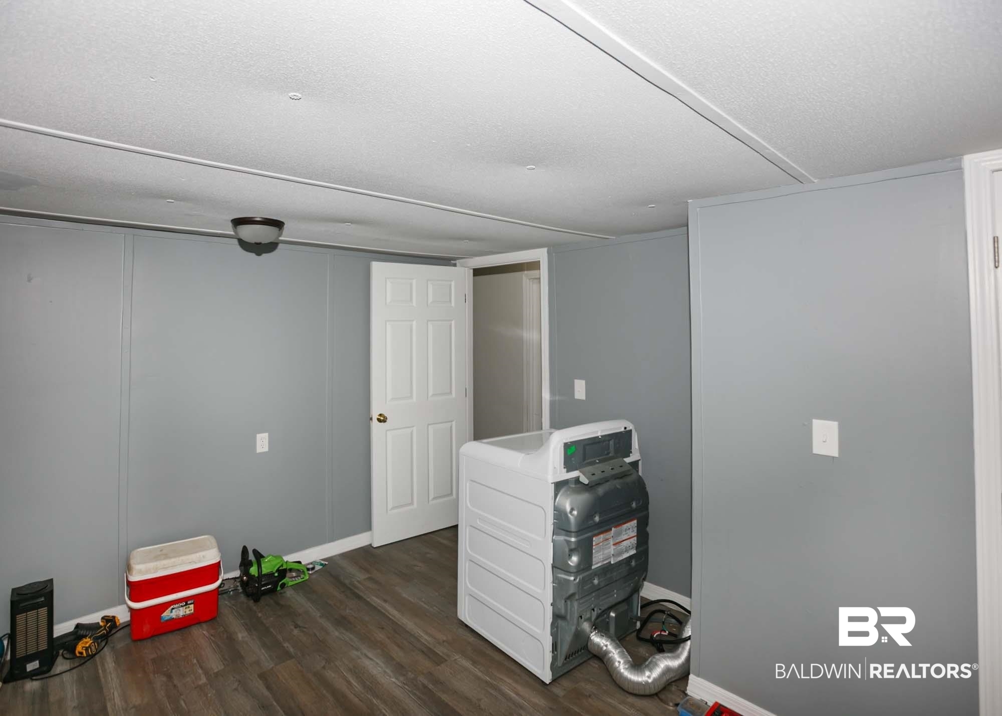 11998 Workman Avenue Foley, AL 36535 - Photo 27 of 59 Basement with dark wood-type flooring and baseboards