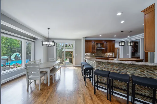 a view of a dining room with furniture large windows and wooden floor