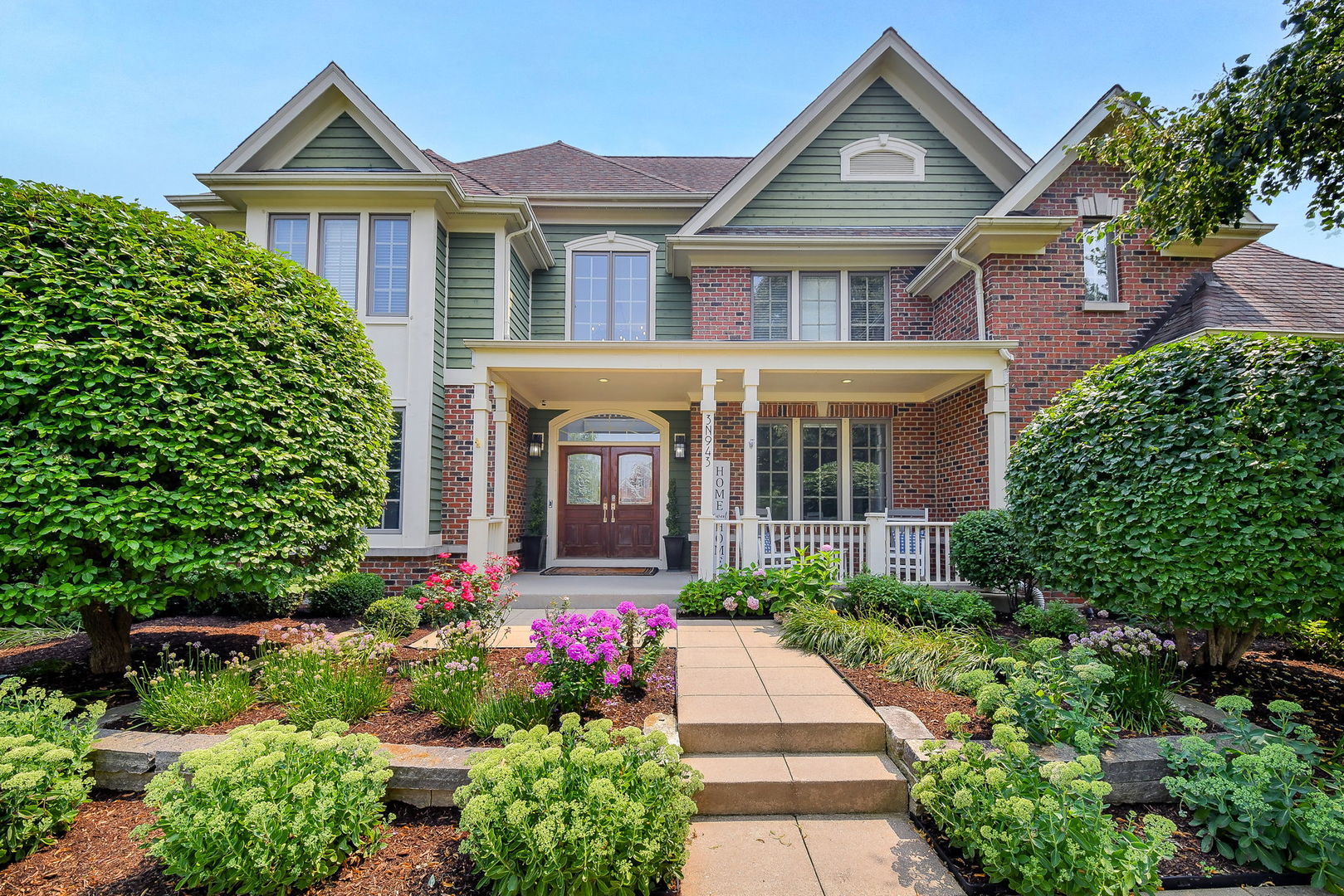3N943 Walt Whitman Road St. Charles, IL 60175 - Photo 2 of 44 a front view of a house with a yard and potted plants