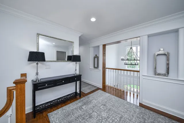 a spacious bedroom with a large bed and a flat tv screen on dresser