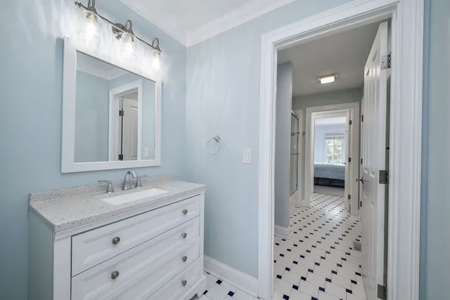 a spacious bedroom with a bed and a chandelier