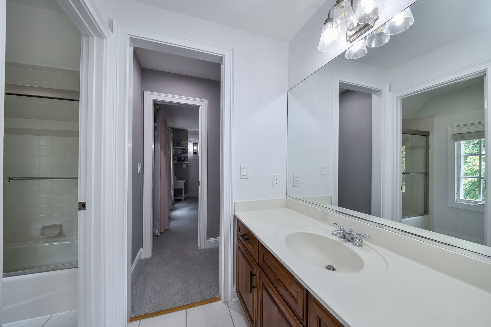 3N943 Walt Whitman Road St. Charles, IL 60175 - Photo 30 of 43 a en suite bathroom with a double vanity sink a large mirror and a shower