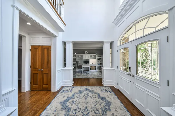 a large room with wooden floor and a rug