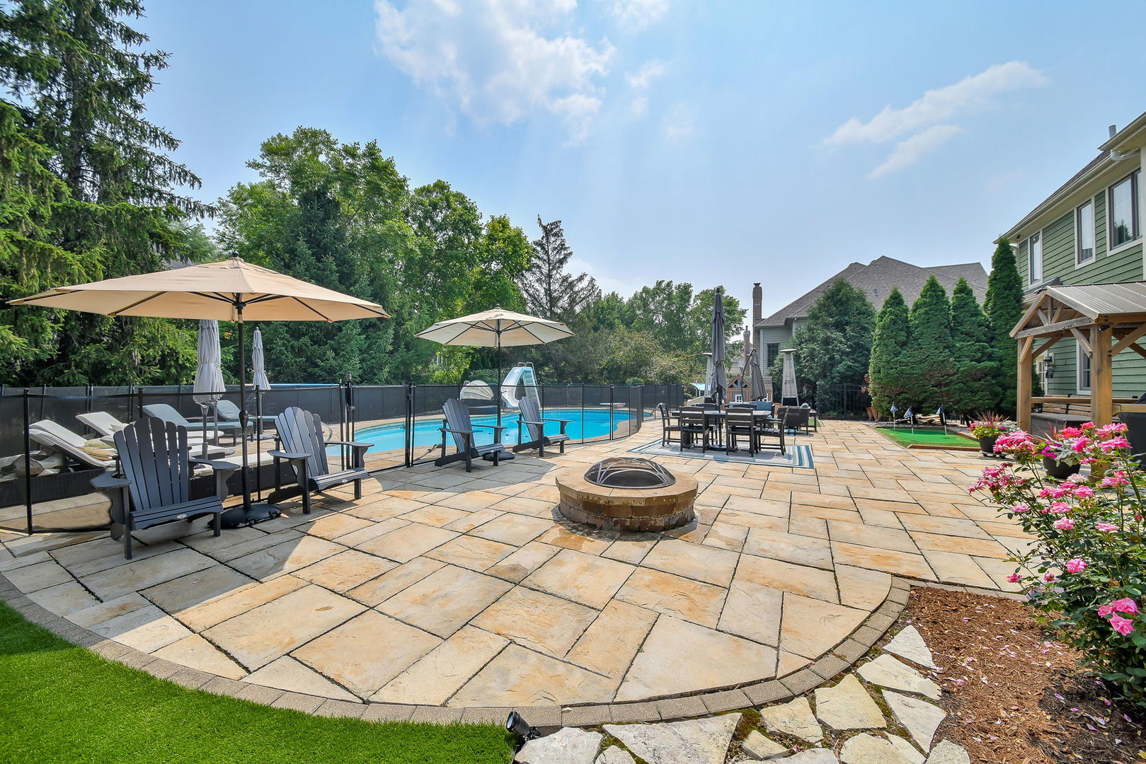 3N943 Walt Whitman Road St. Charles, IL 60175 - Photo 42 of 44 a view of a patio with a table and chairs under an umbrella
