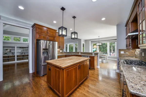 a kitchen with stainless steel appliances granite countertop a sink stove and refrigerator