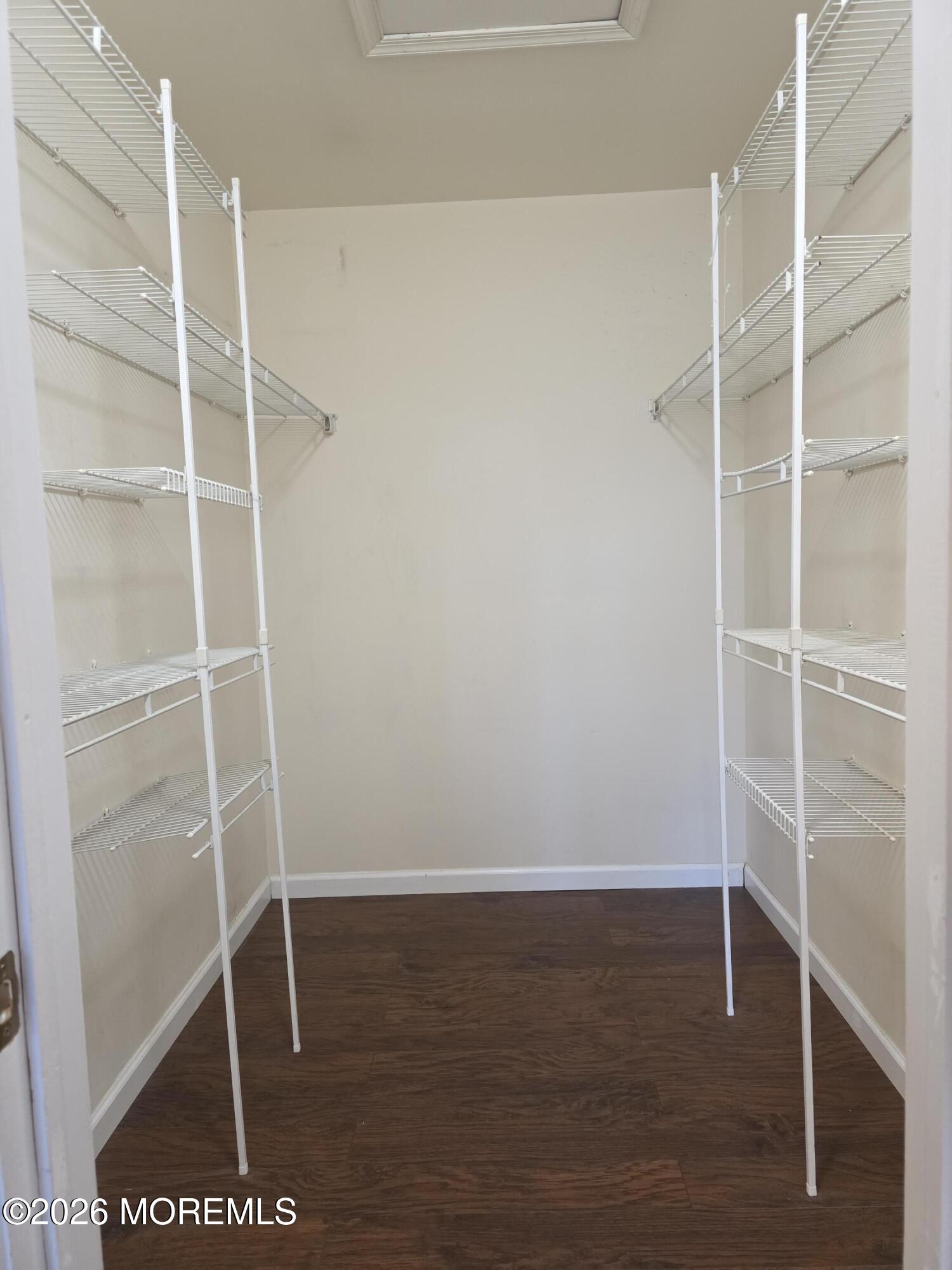 5 Claridge Court, Unit 4 Freehold, NJ 07728 - Photo 11 of 13 a room with wooden floor and a window