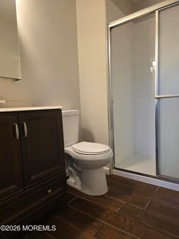 a white toilet sitting next to a shower