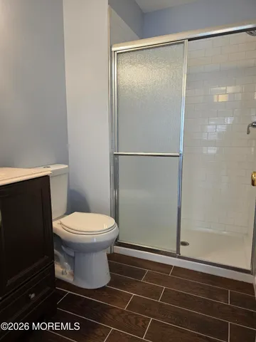 a bathroom with a toilet and a shower