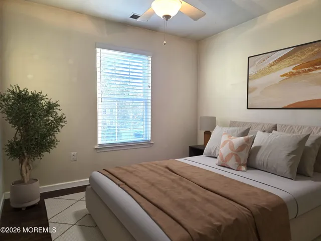 a bedroom with a bed and a potted plant