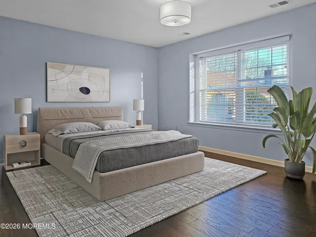 a bedroom with a large bed and a window