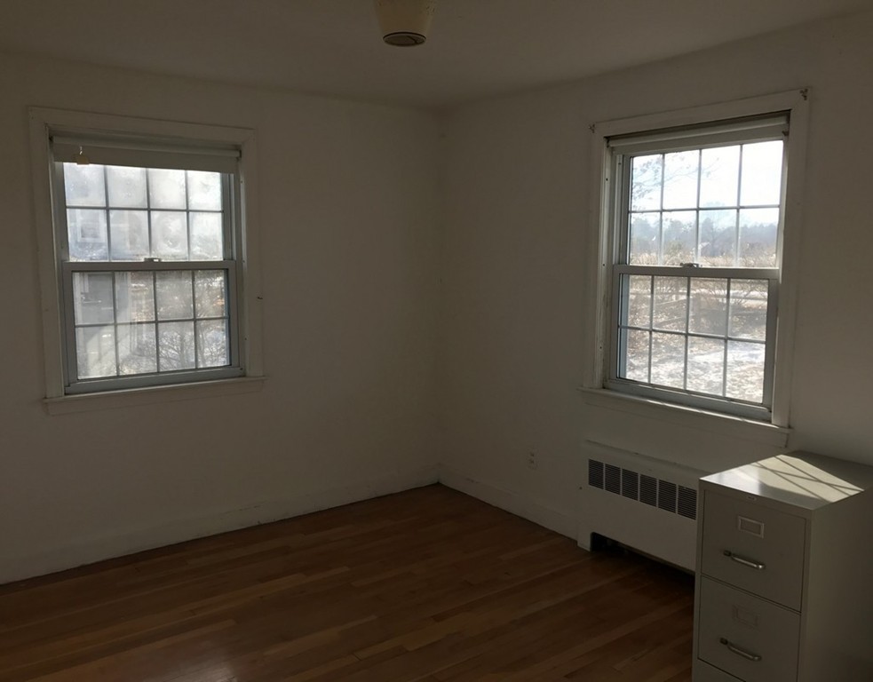 113 Peter Spring Road Concord, MA 01742 - Photo 12 of 13 an empty room with wooden floor and windows