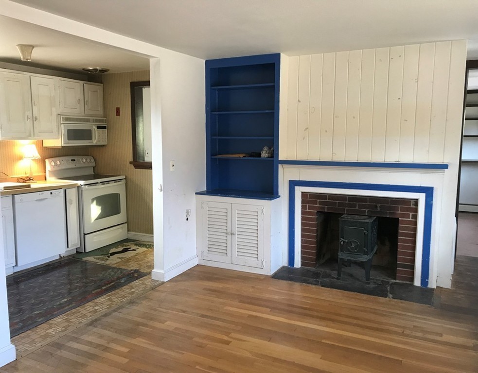 113 Peter Spring Road Concord, MA 01742 - Photo 7 of 13 a kitchen with a fireplace